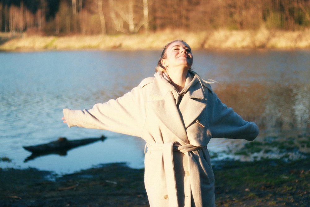 a person standing next to a body of water