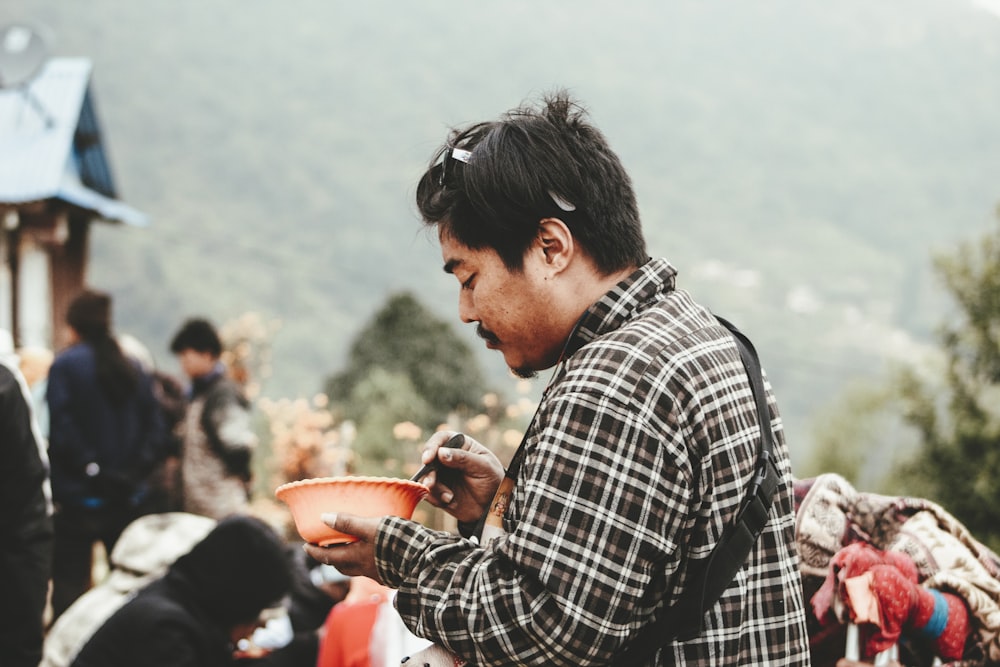 a man holding a plate of food in his hands