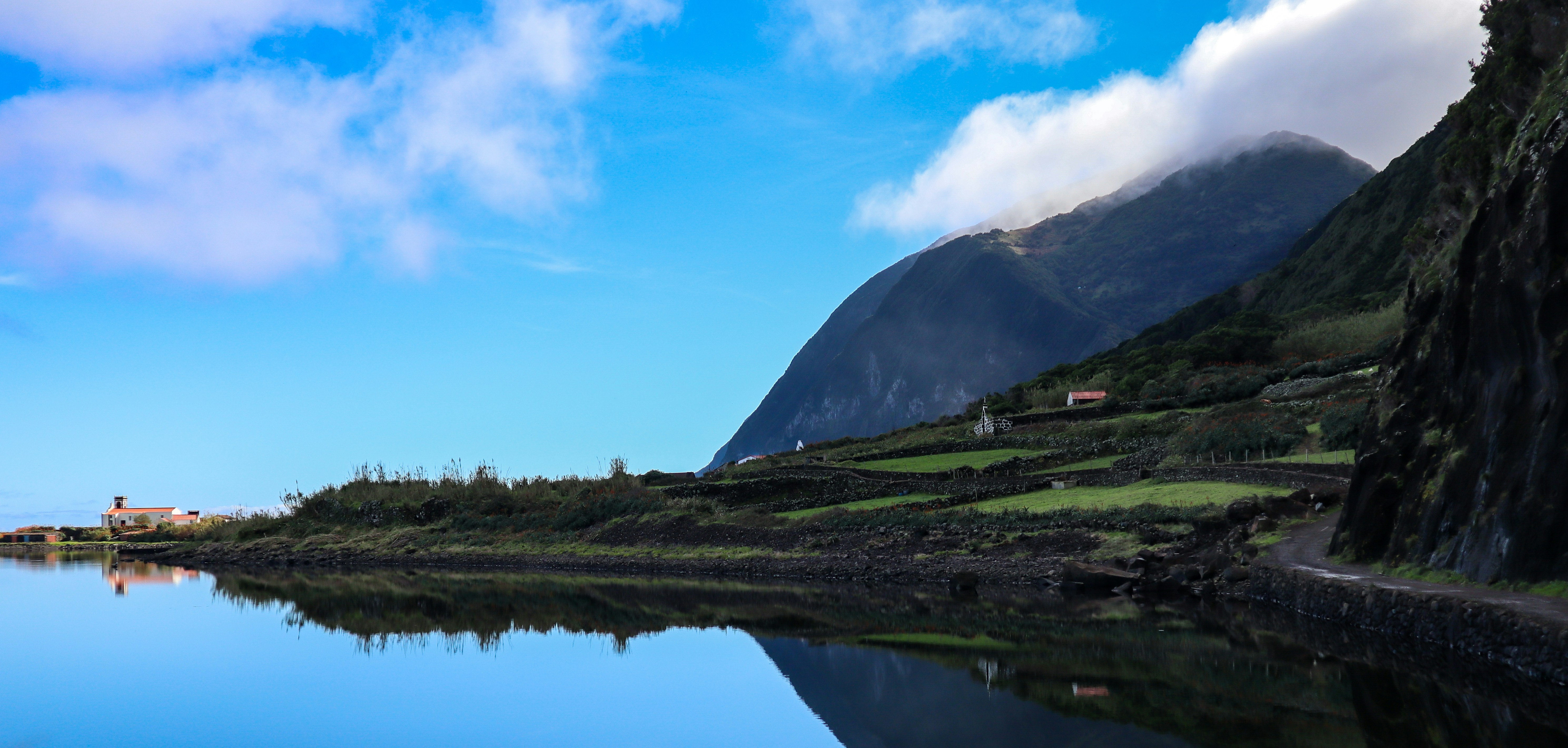 a body of water with mountains in the background