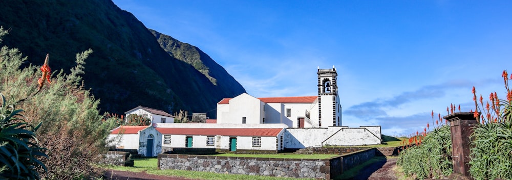 a white church with a steeple on a hill