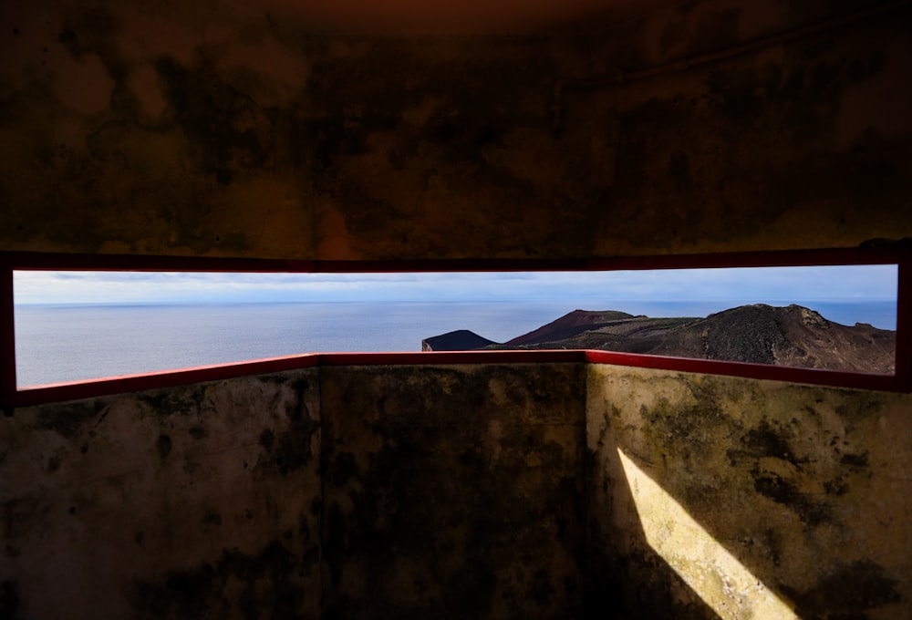 a view of the ocean from a window in a building