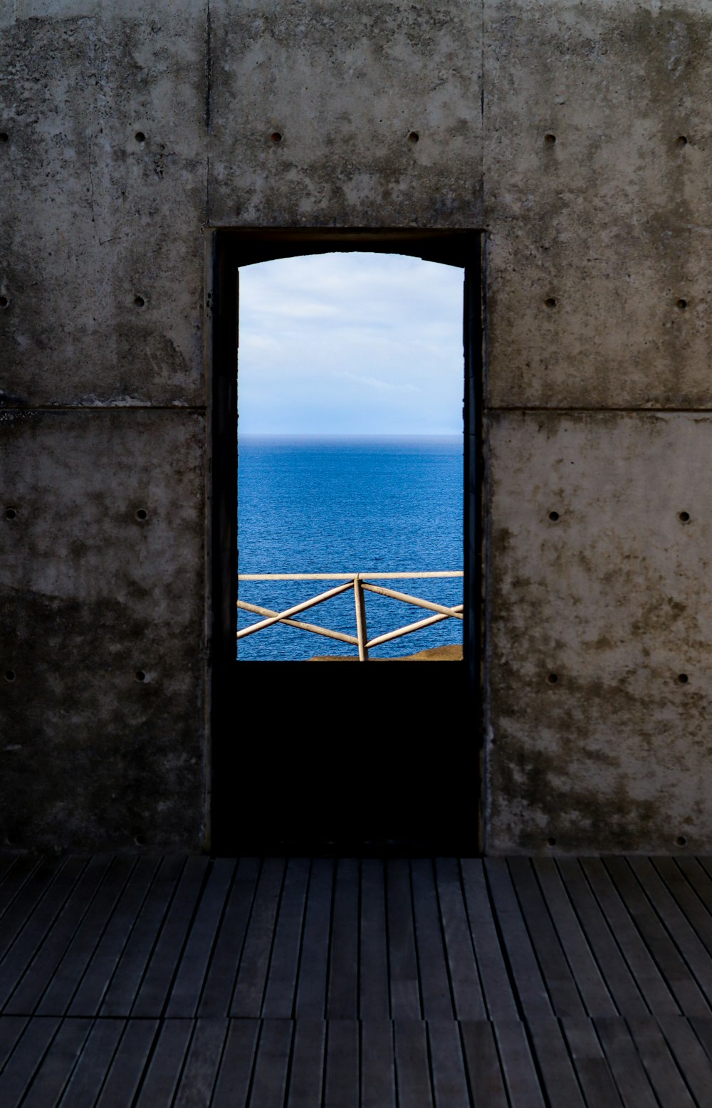 an open door with a view of the ocean