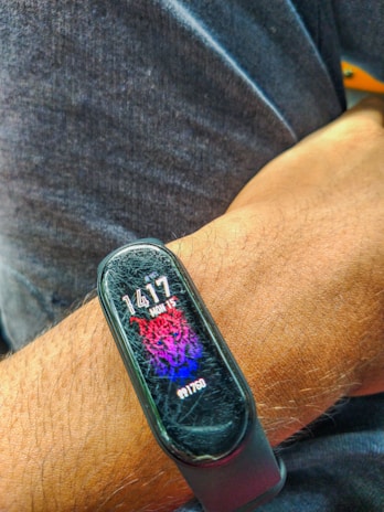 A close-up of a Healthbear2.0 wearable on a wrist during a morning run in soft sunlight.