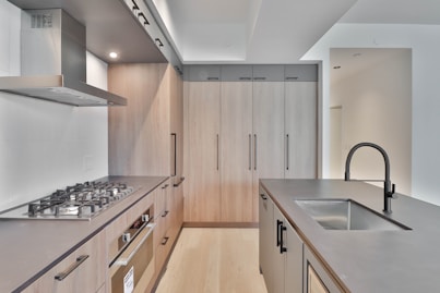 a kitchen with a stove top oven and a sink