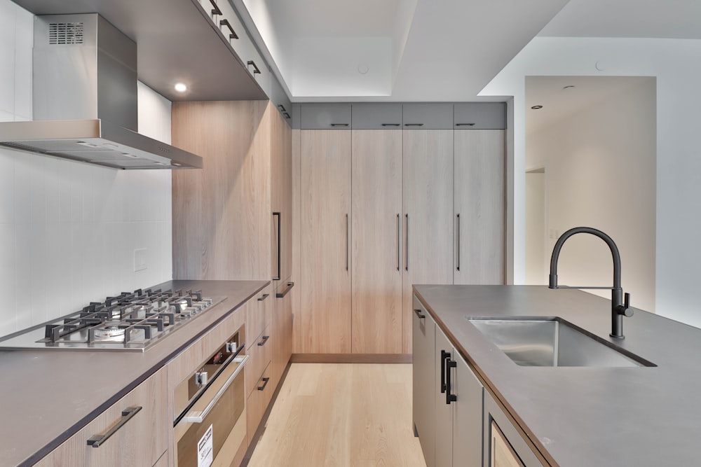 a kitchen with a stove top oven and a sink