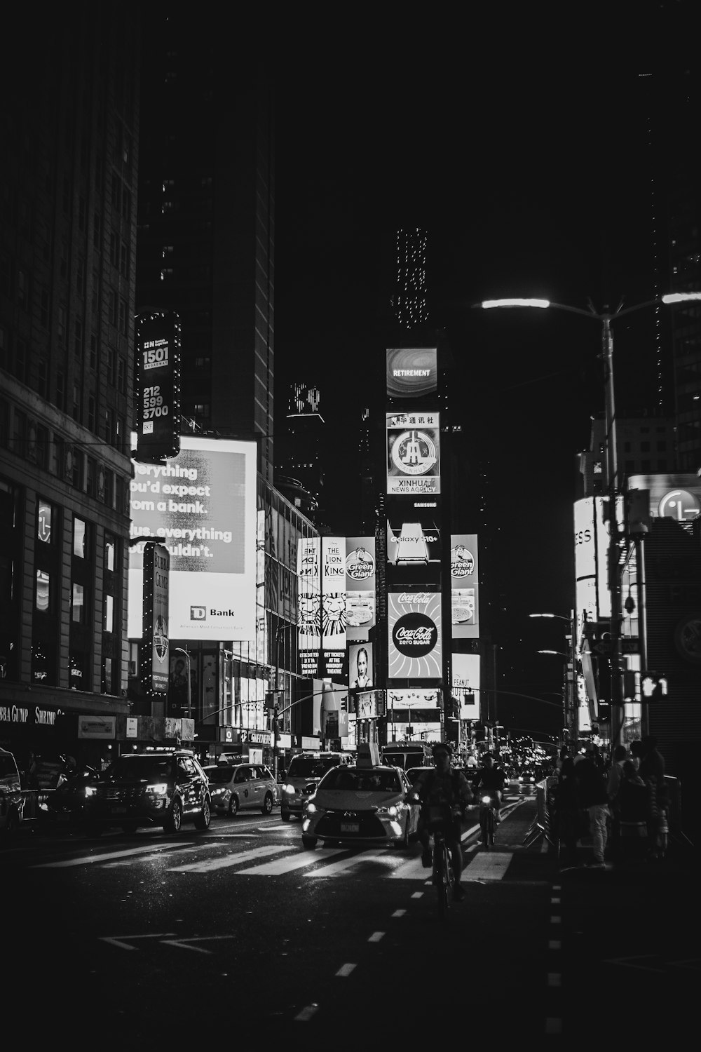 a black and white photo of a city street at night