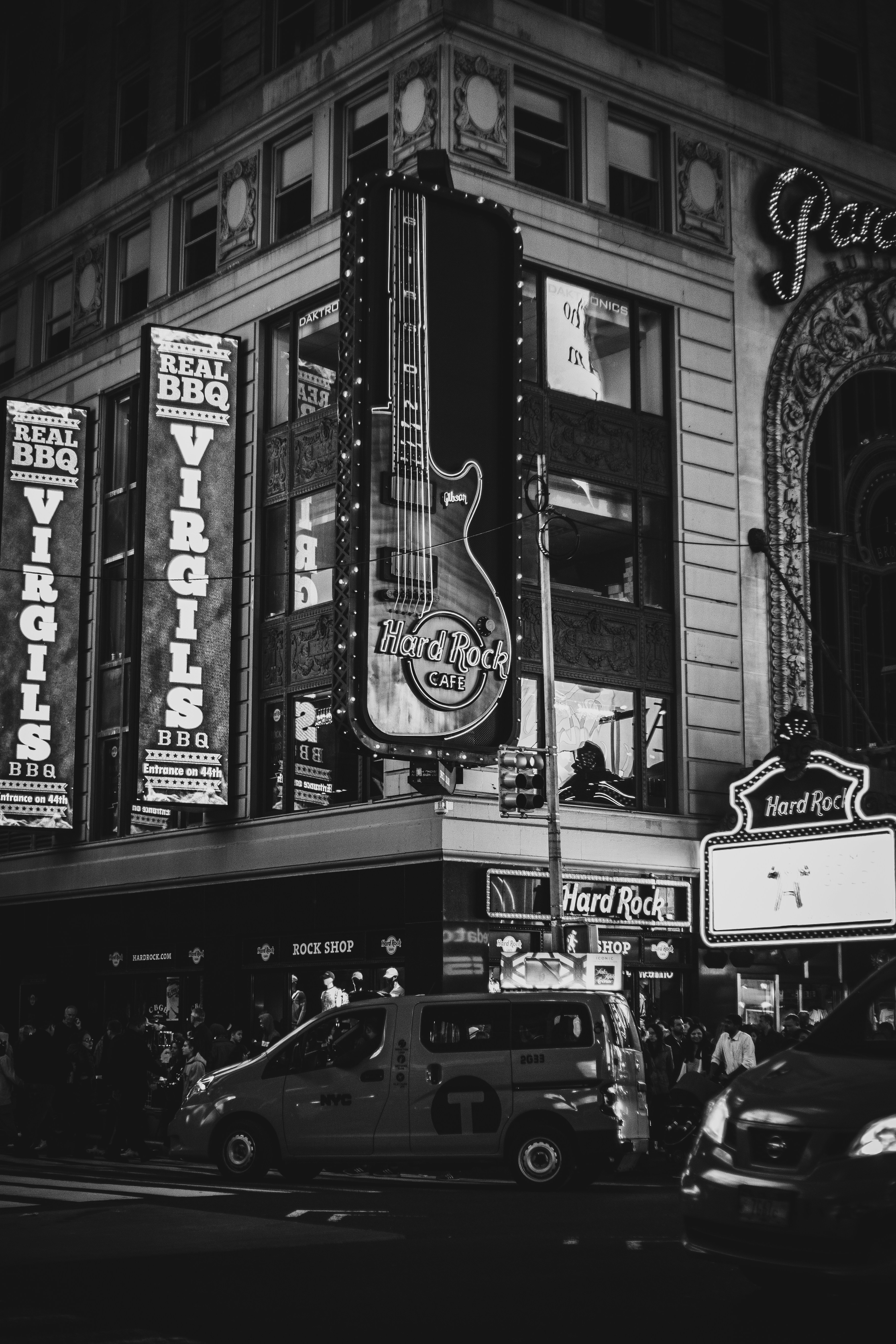 a black and white photo of a building with a guitar sign