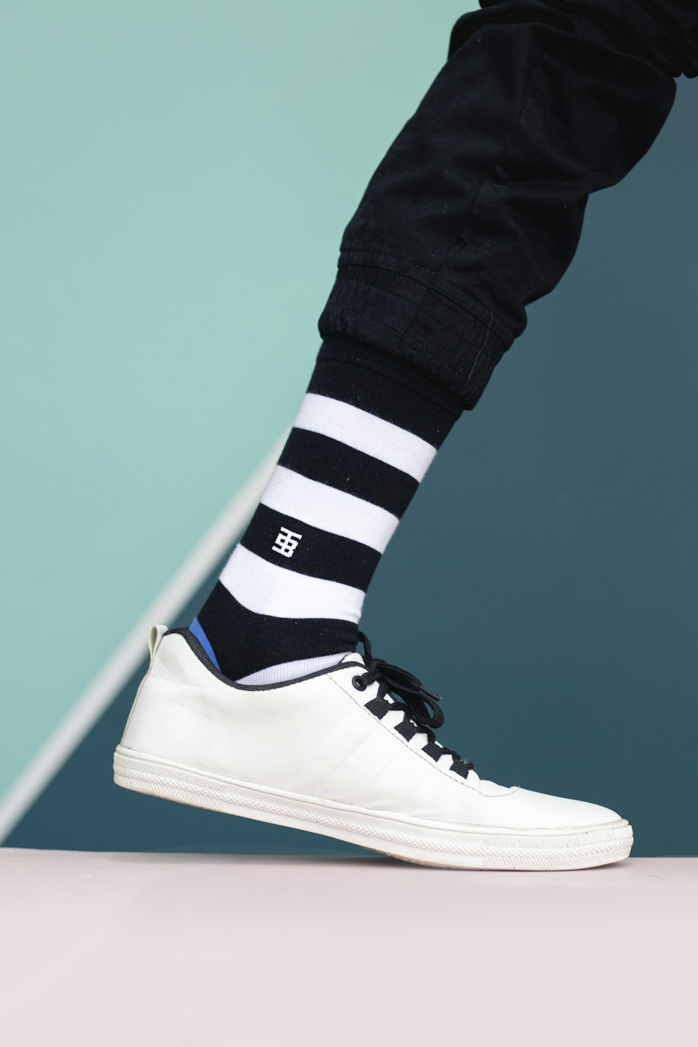 a person wearing black and white striped socks