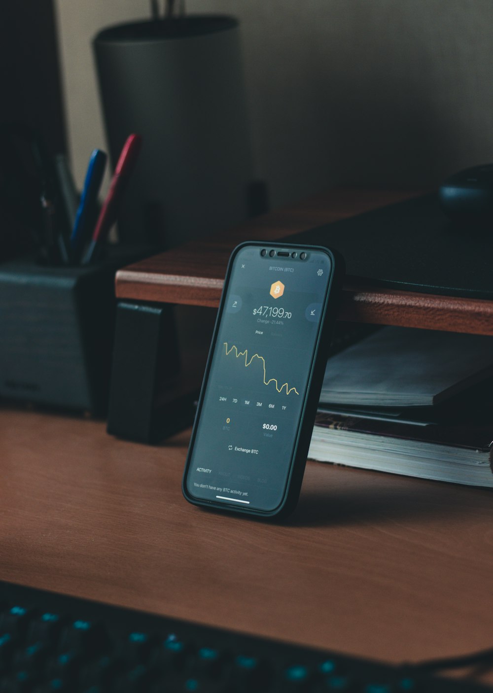 a cell phone sitting on top of a wooden desk