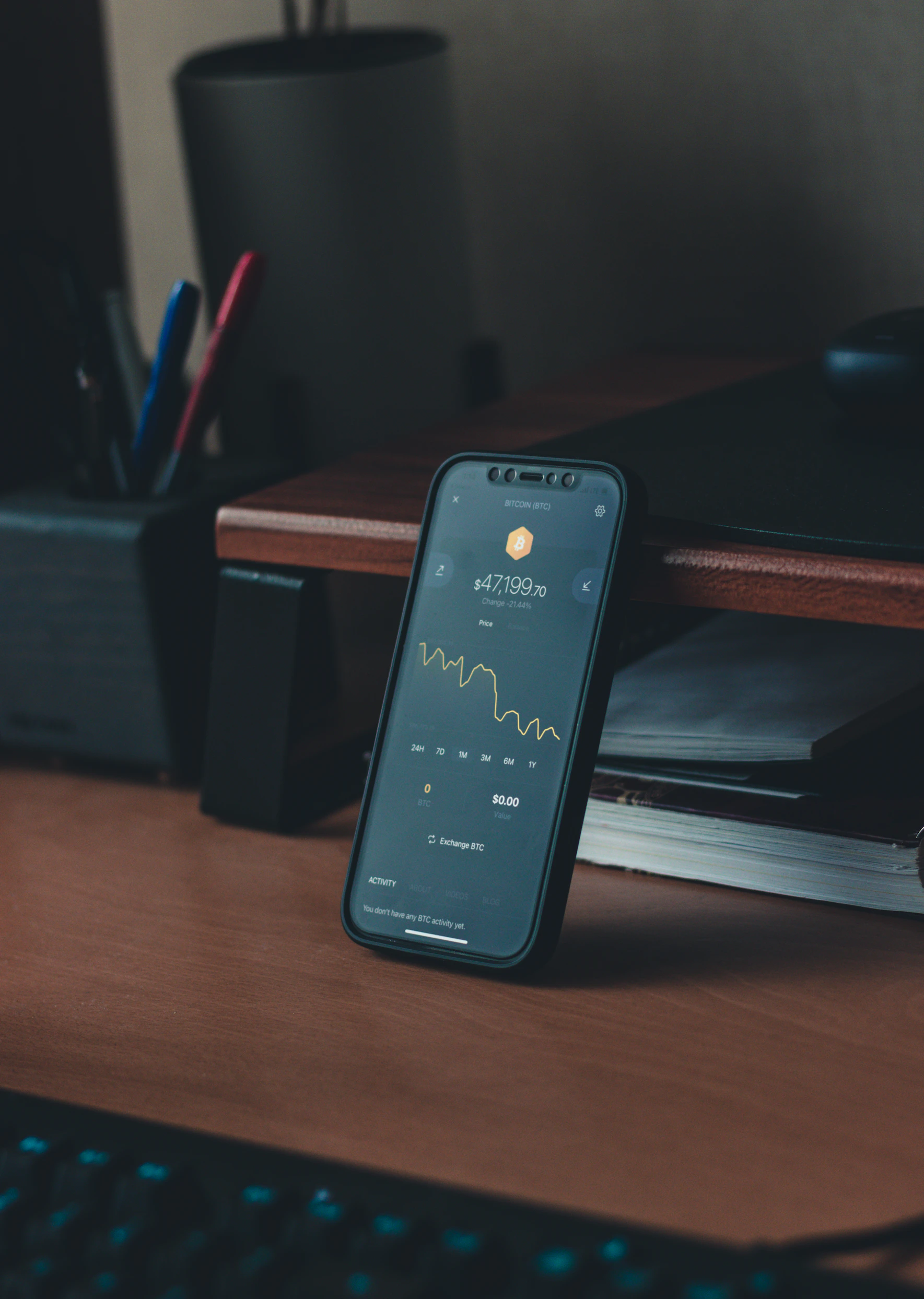 Mobile phone displaying crypto market information on a desk