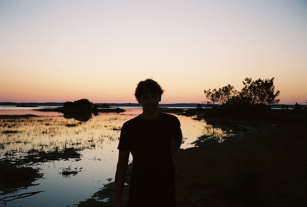 a person standing in front of a body of water