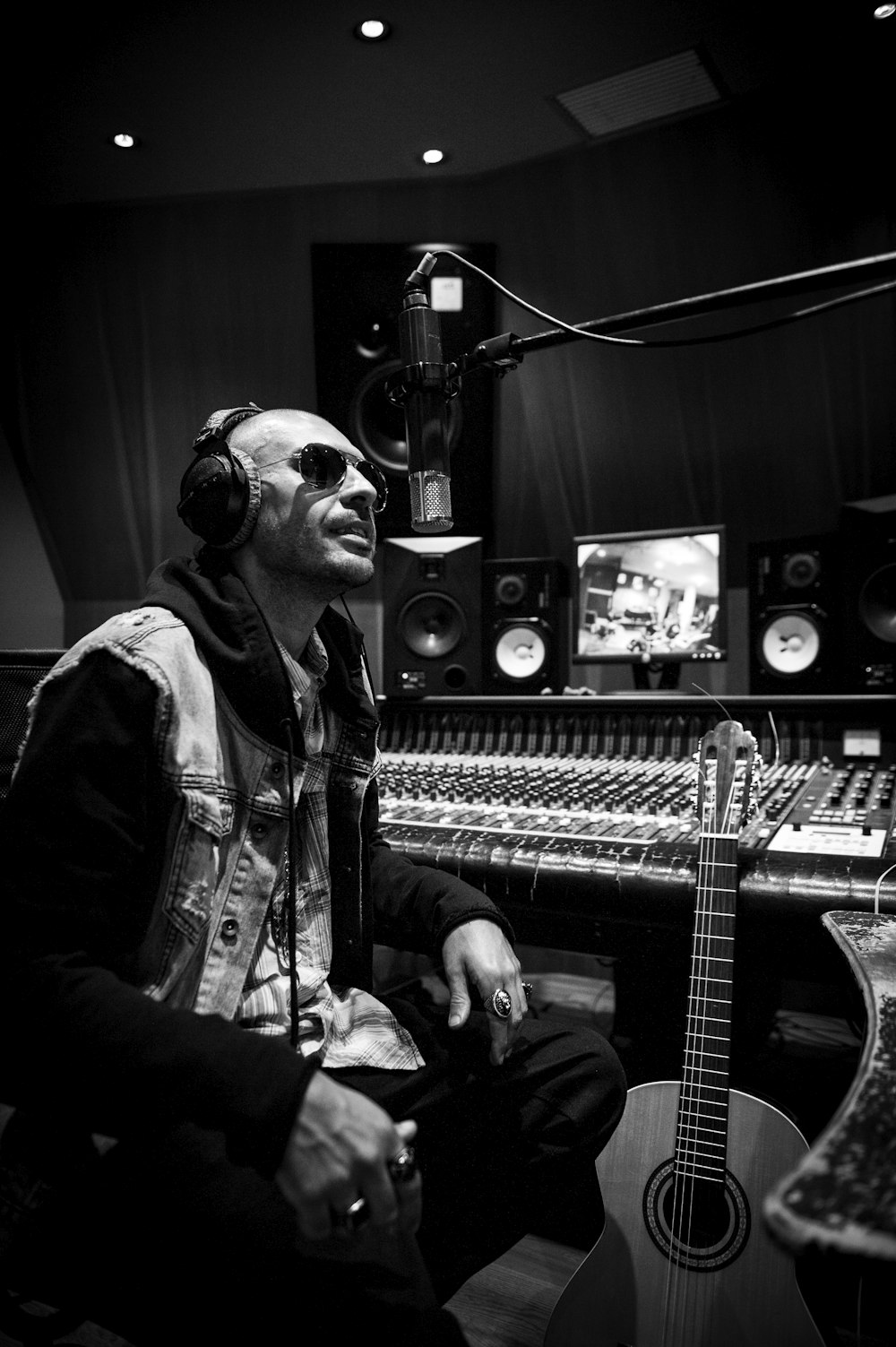 a man sitting in a recording studio with headphones on