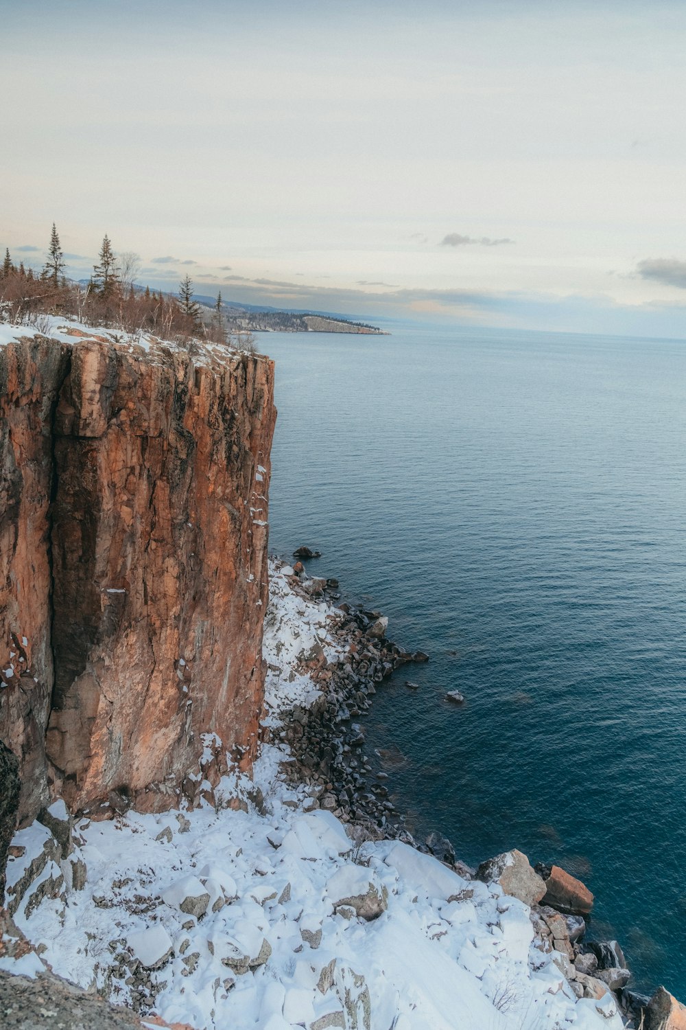 a rocky cliff overlooks a body of water