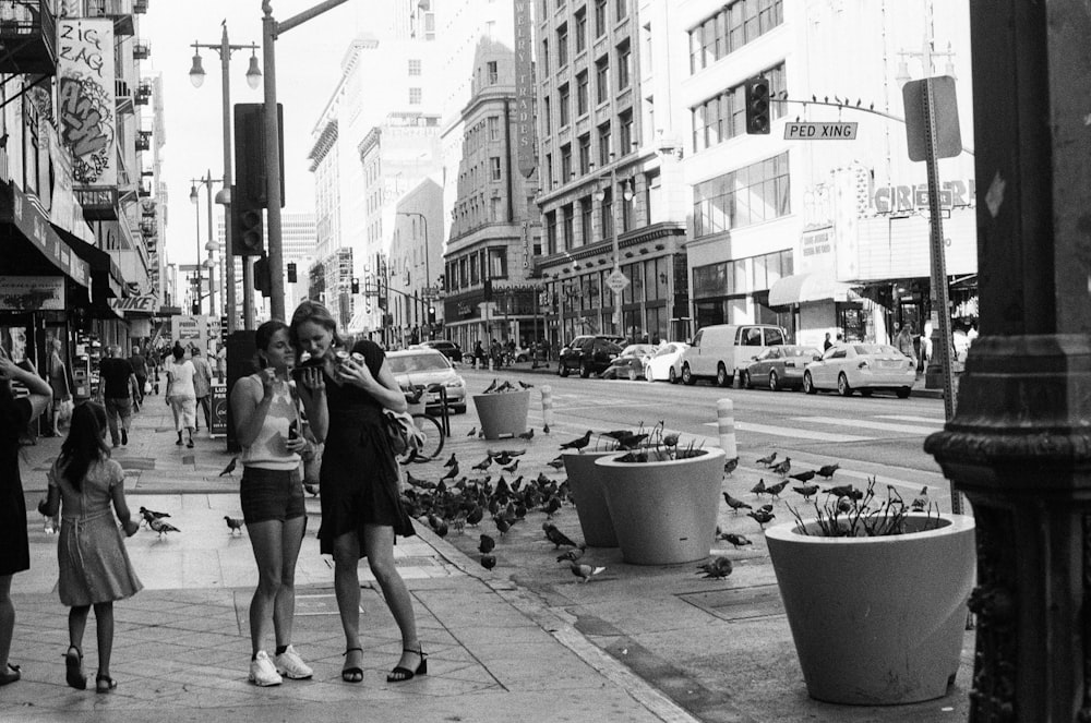 a black and white photo of a group of people on a city street