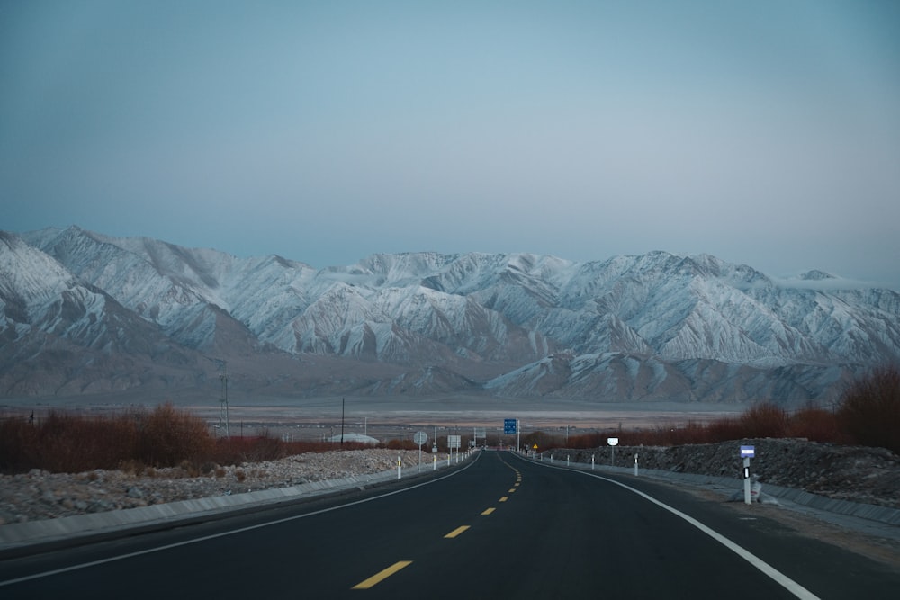 a road with a mountain range in the background