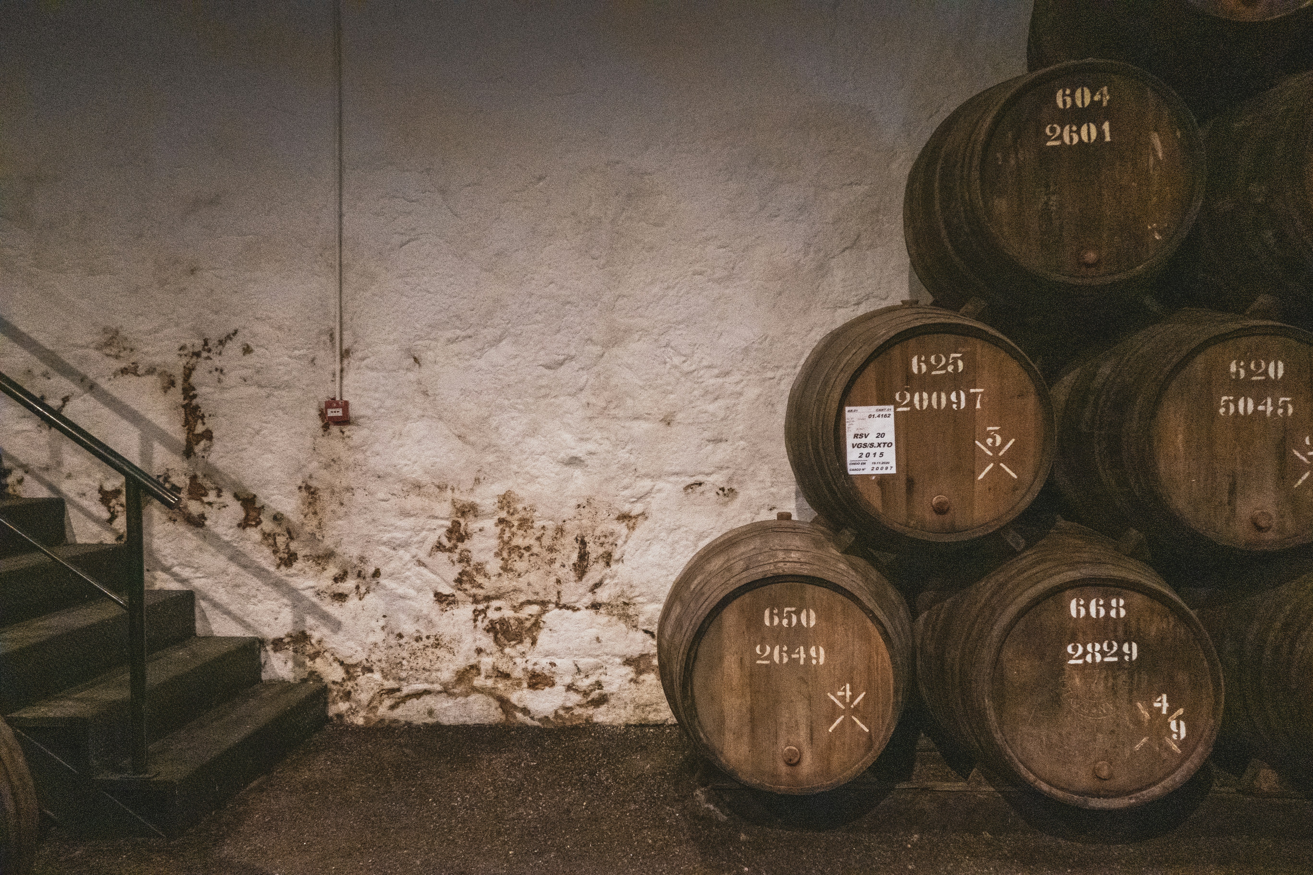Wine barrels stacked against wall