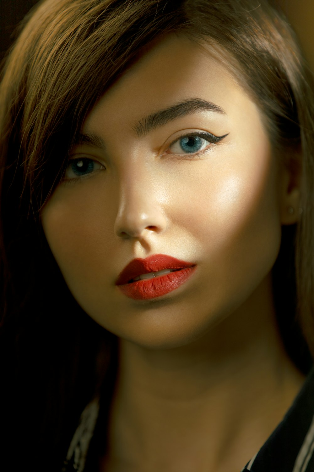 a close up of a woman with red lipstick