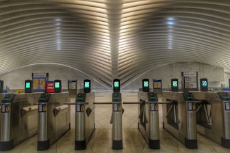 Modern turnstiles and flap barriers installed at a busy office lobby