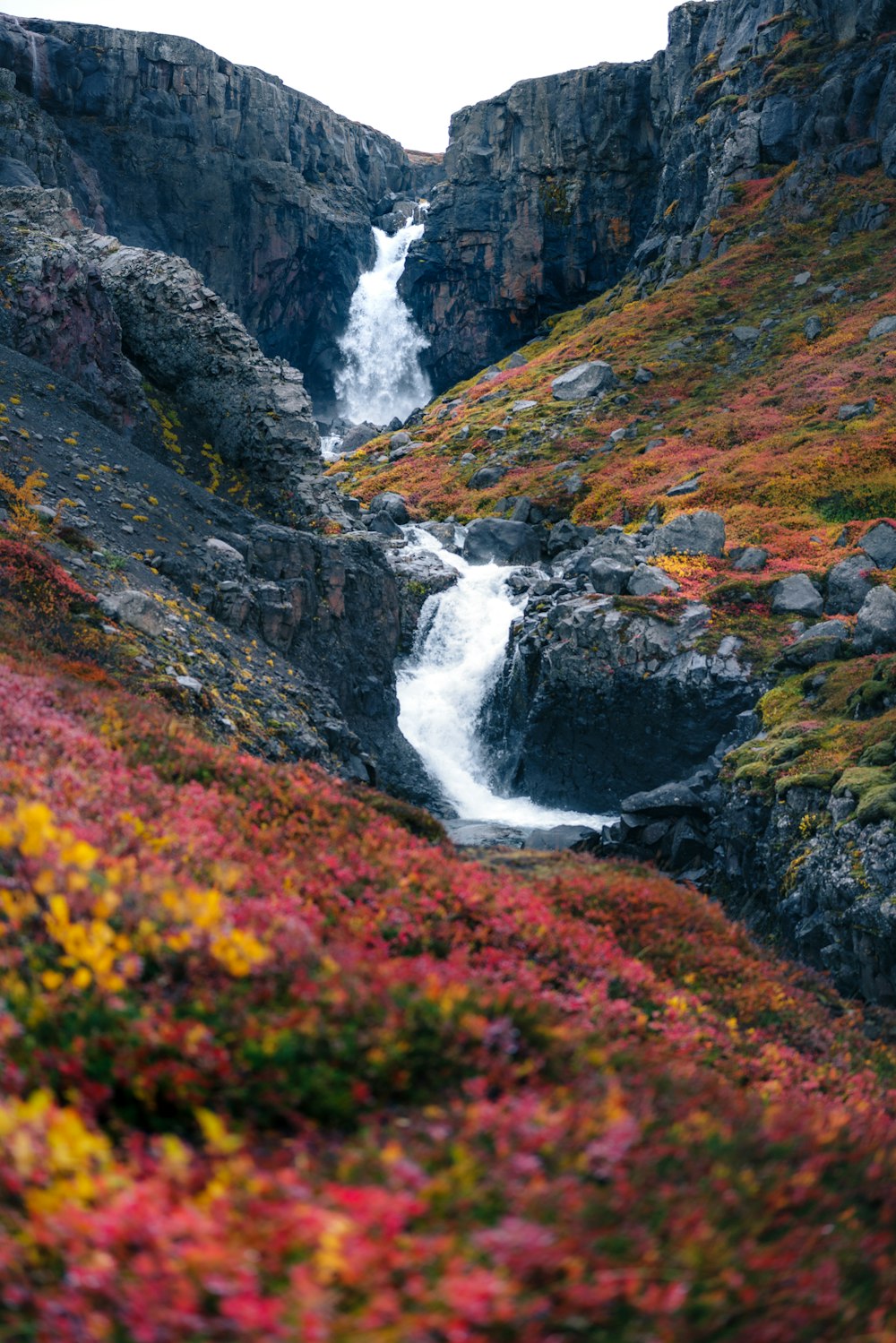 a waterfall in the middle of a rocky area