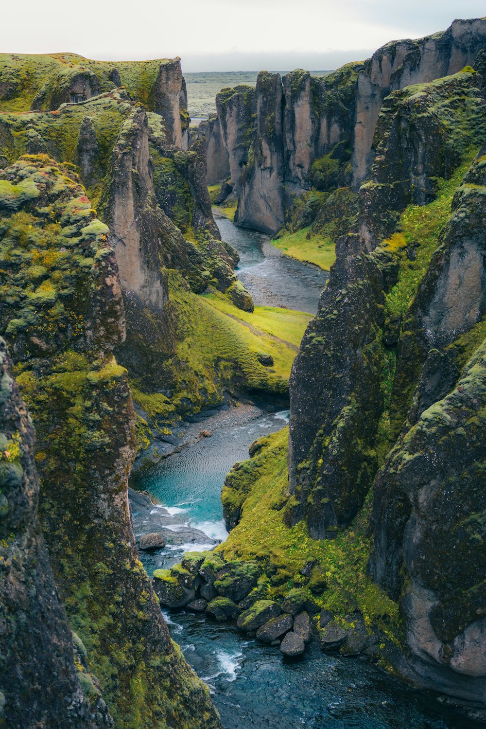 a river flowing through a lush green valley