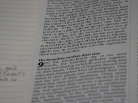 A close-up view of a page from a book with printed text and headings. The text appears to describe historical or religious events, with sections and subsections. There are faint handwritten notes or sketches in the margins.