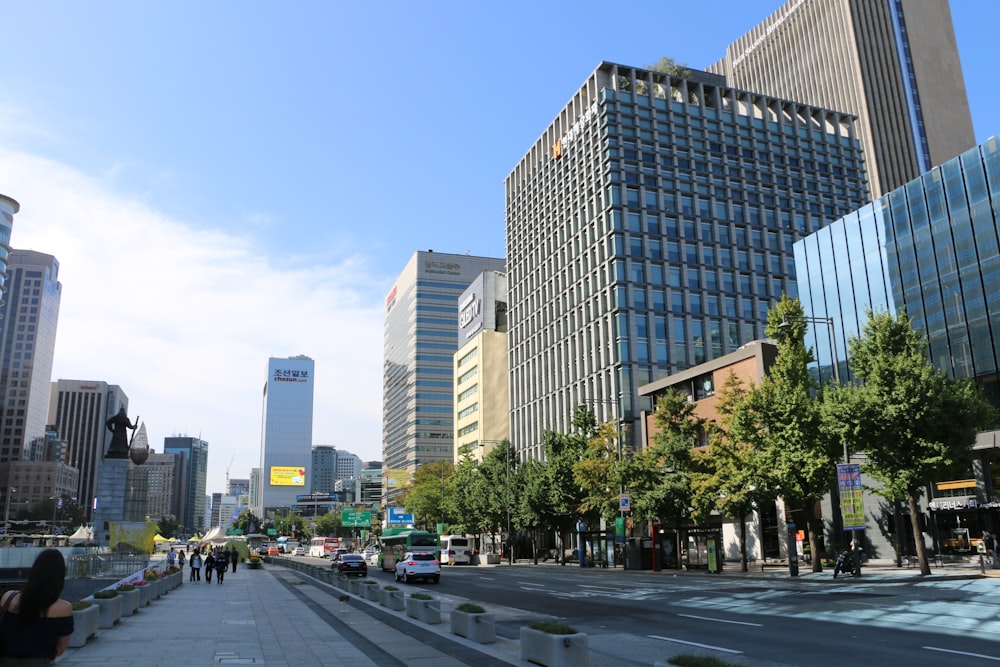 a city street lined with tall buildings and trees