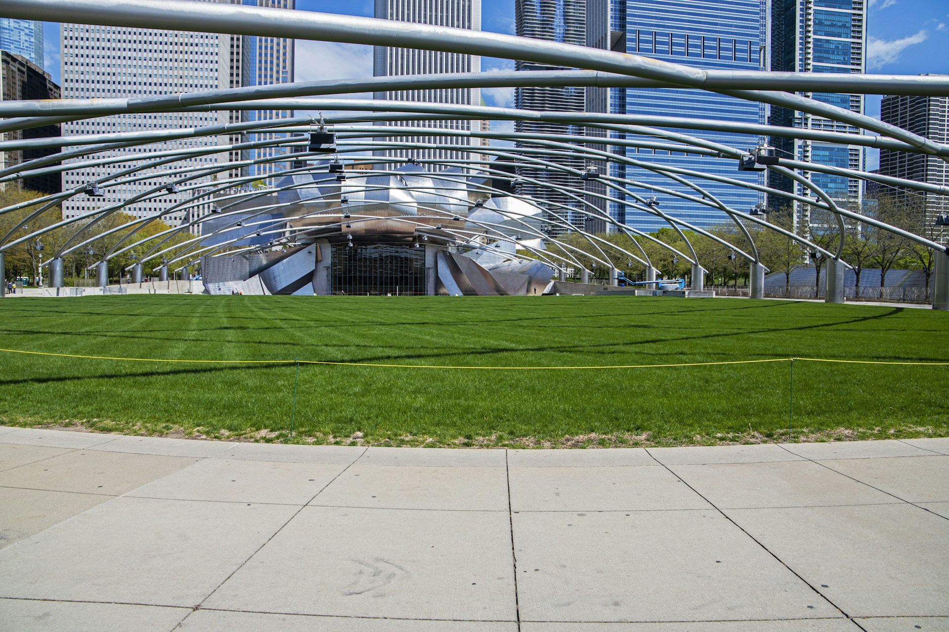 woman wearing yellow long-sleeved dress under white clouds and blue sky during daytime