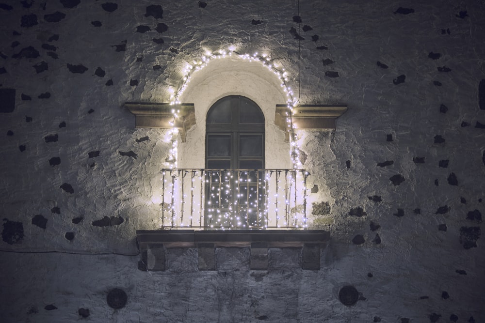 a balcony with lights and a balcony railing