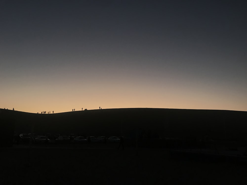 a group of people standing on top of a hill