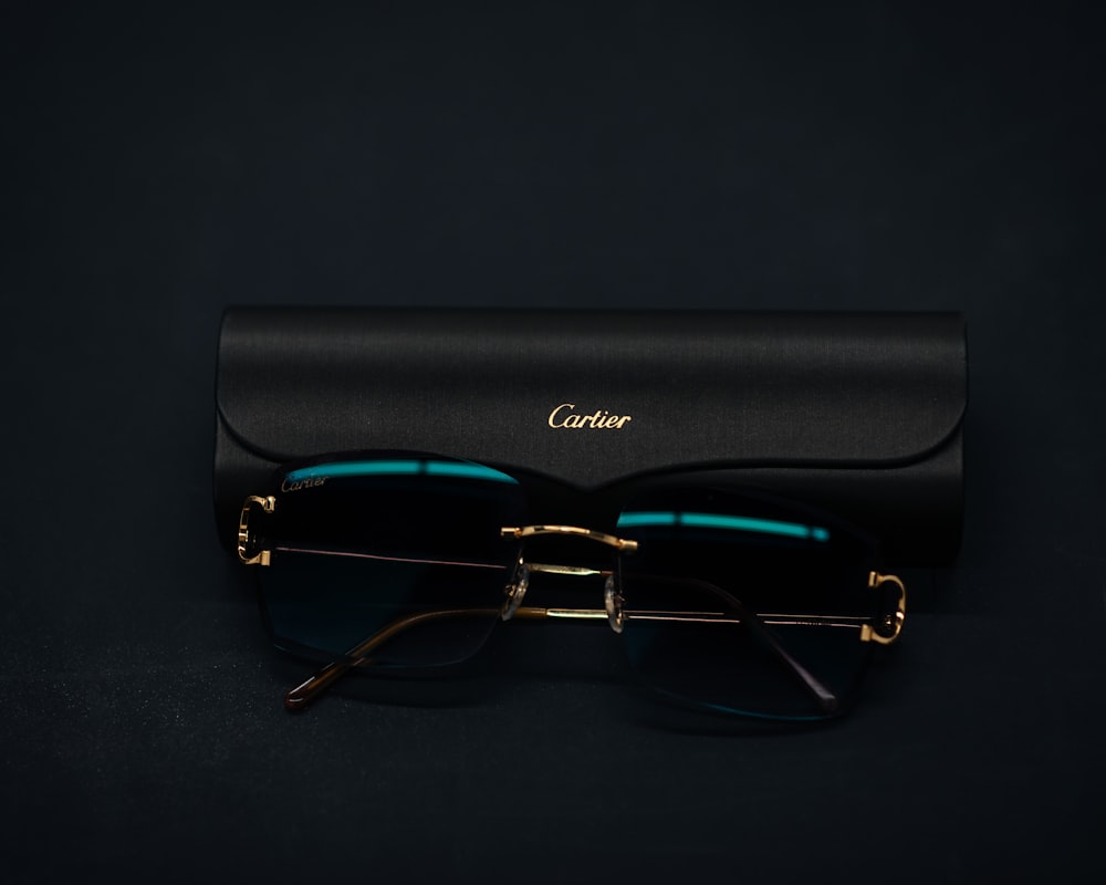 a pair of glasses sitting on top of a black case