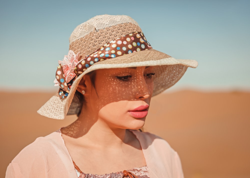 a woman wearing a hat in the desert