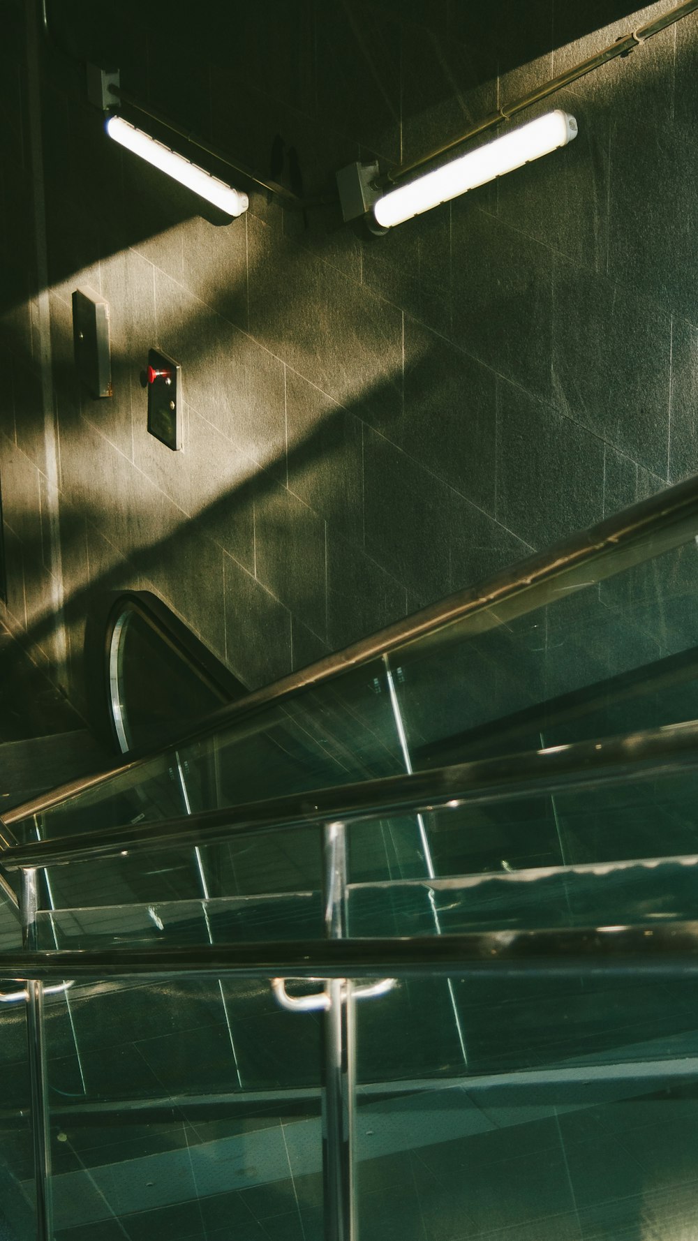 an escalator in a building with metal railings