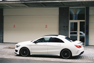 a white car parked in front of a building