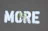 a blurry picture of the word more on a wall