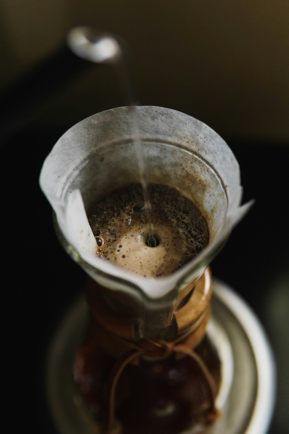 a coffee pot filled with liquid sitting on top of a saucer