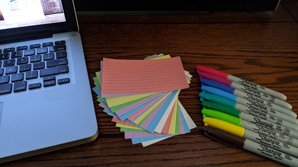 A collection of printed cybersecurity templates spread out on a wooden desk.