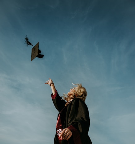 a woman flying a kite in a blue sky