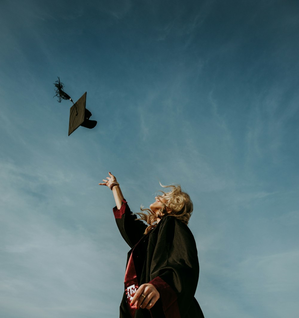 a woman flying a kite in a blue sky