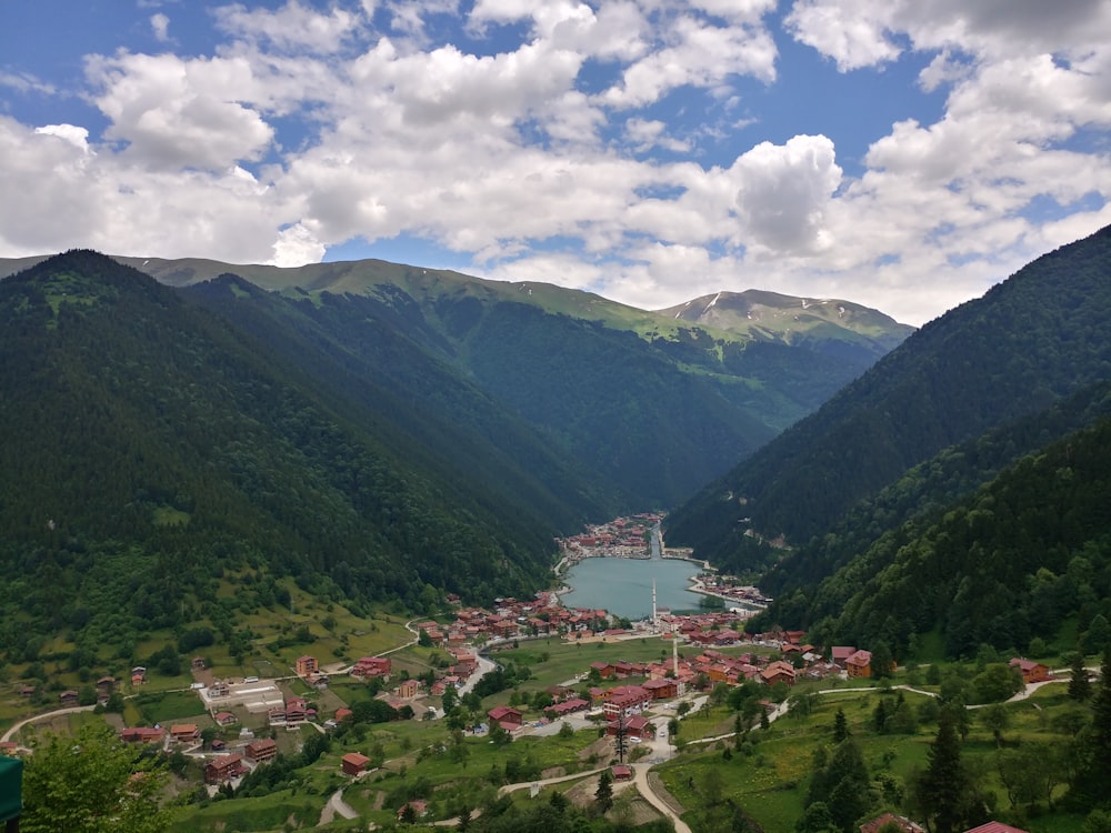 a scenic view of a small town in the mountains