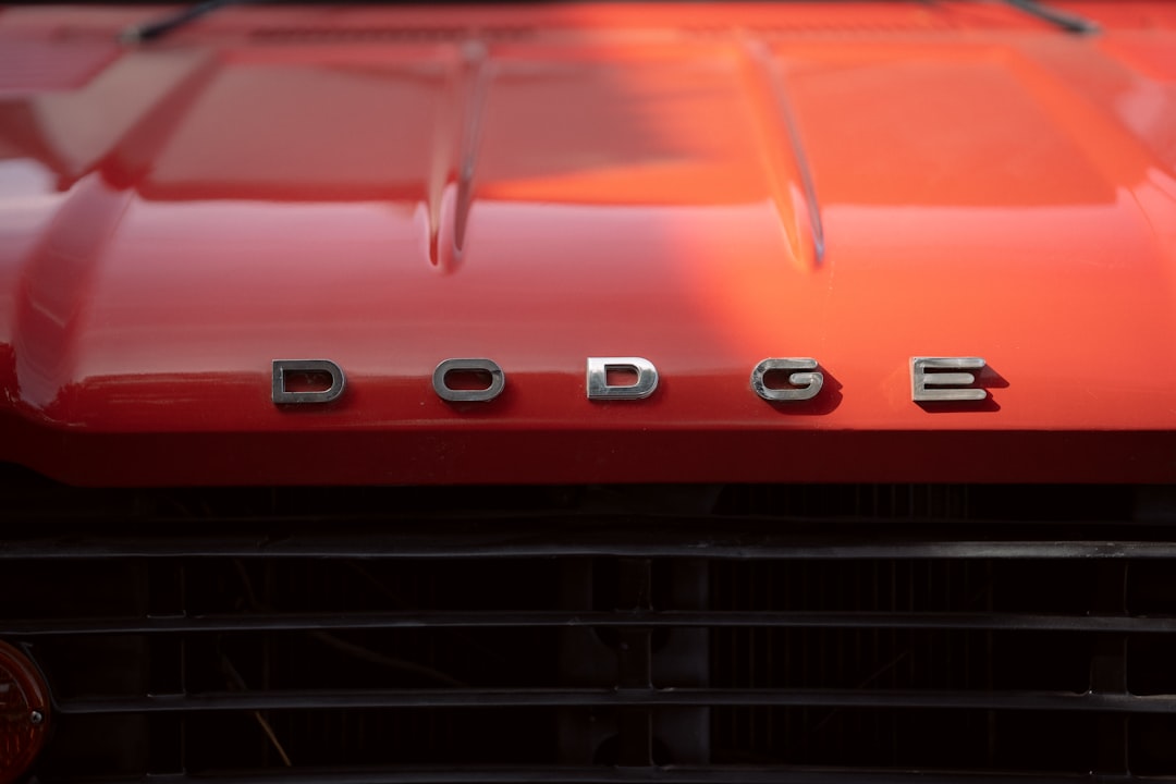 a close up of the front of a red dodge truck,