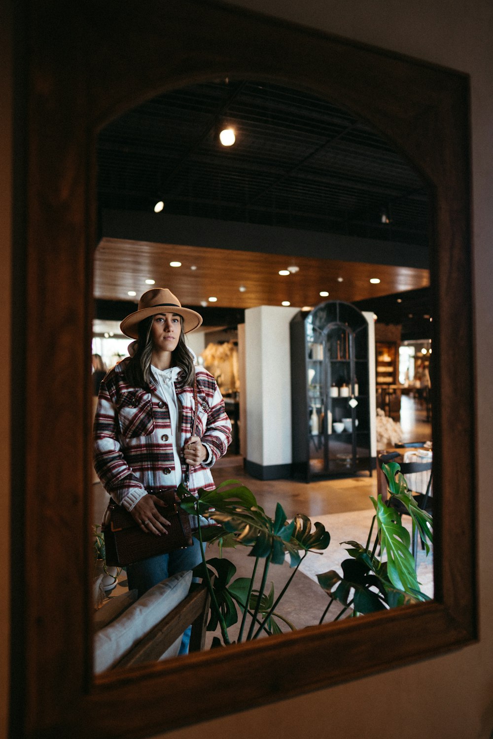 a woman standing in front of a mirror