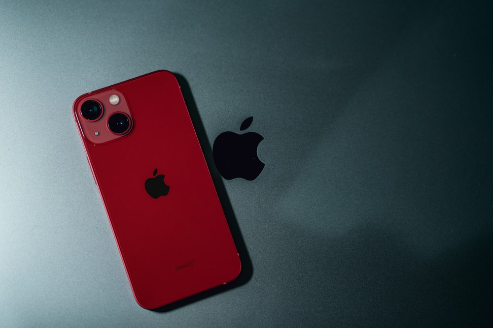 a red iphone sitting on top of a table