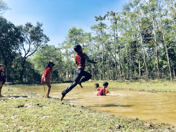 Children happily engaged in outdoor play surrounded by lush greenery in Chikmagalur.