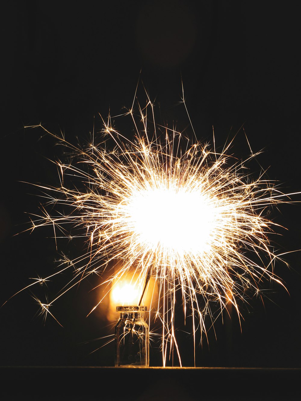 a firework is lit up in the night sky