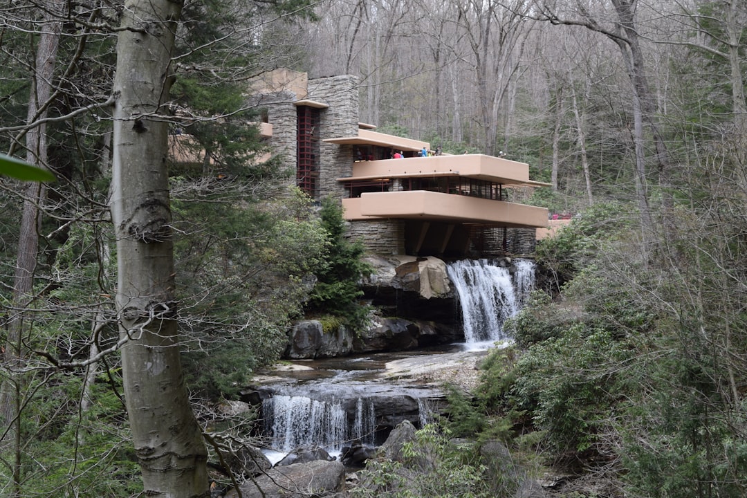 a house in the woods with a waterfall, Fallingwater is one of the most unique houses in the world, and it needed people just as unique to help make this timeless treasure a reality.