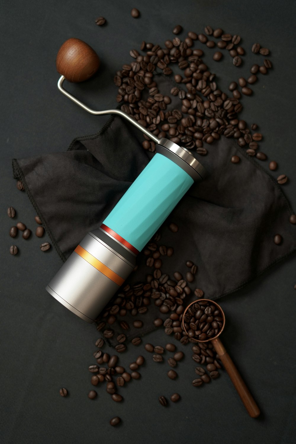 a coffee grinder sitting on top of a pile of coffee beans