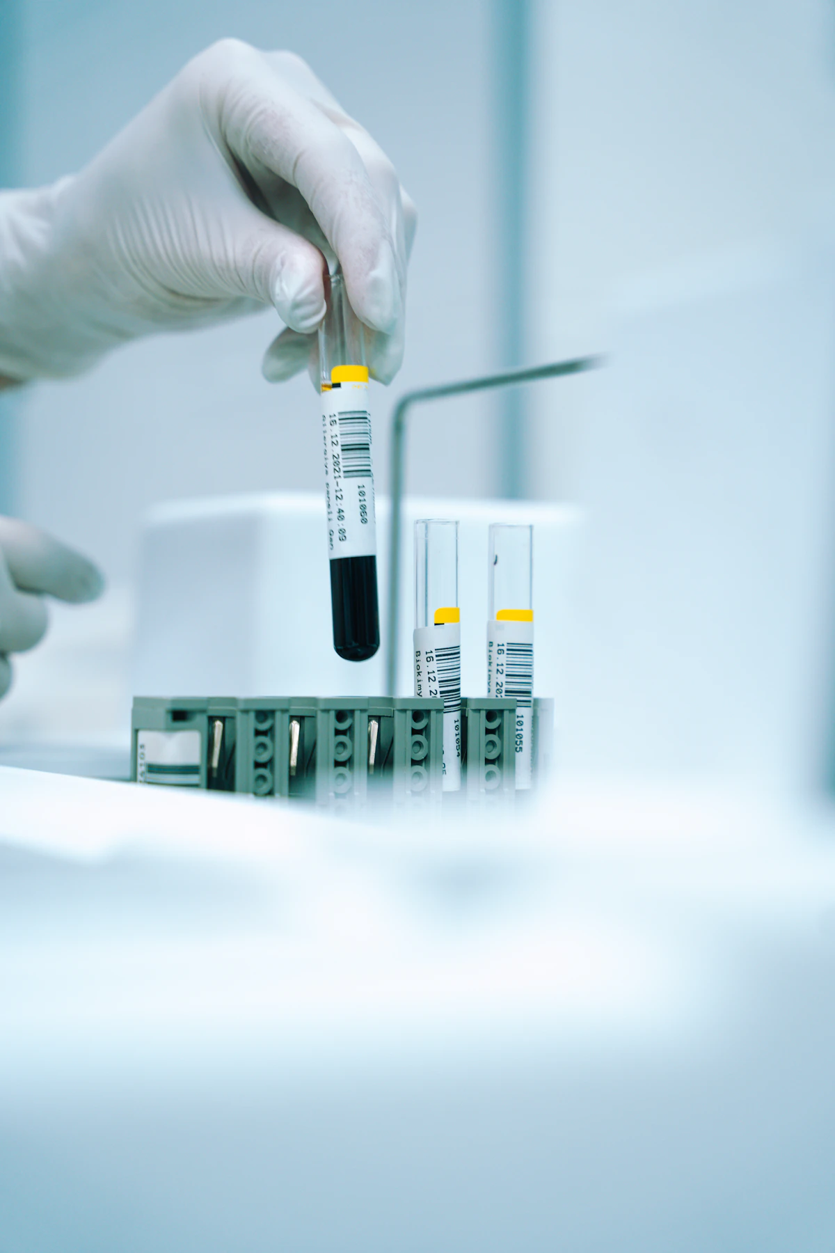 Researcher holding a test tube of reformulated liquid in a lab