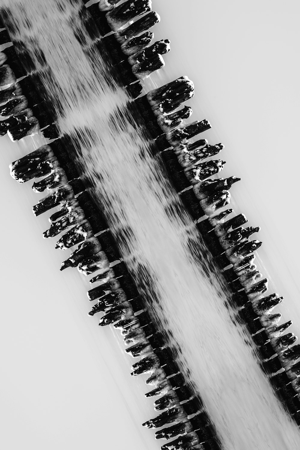 a black and white photo of a water fountain