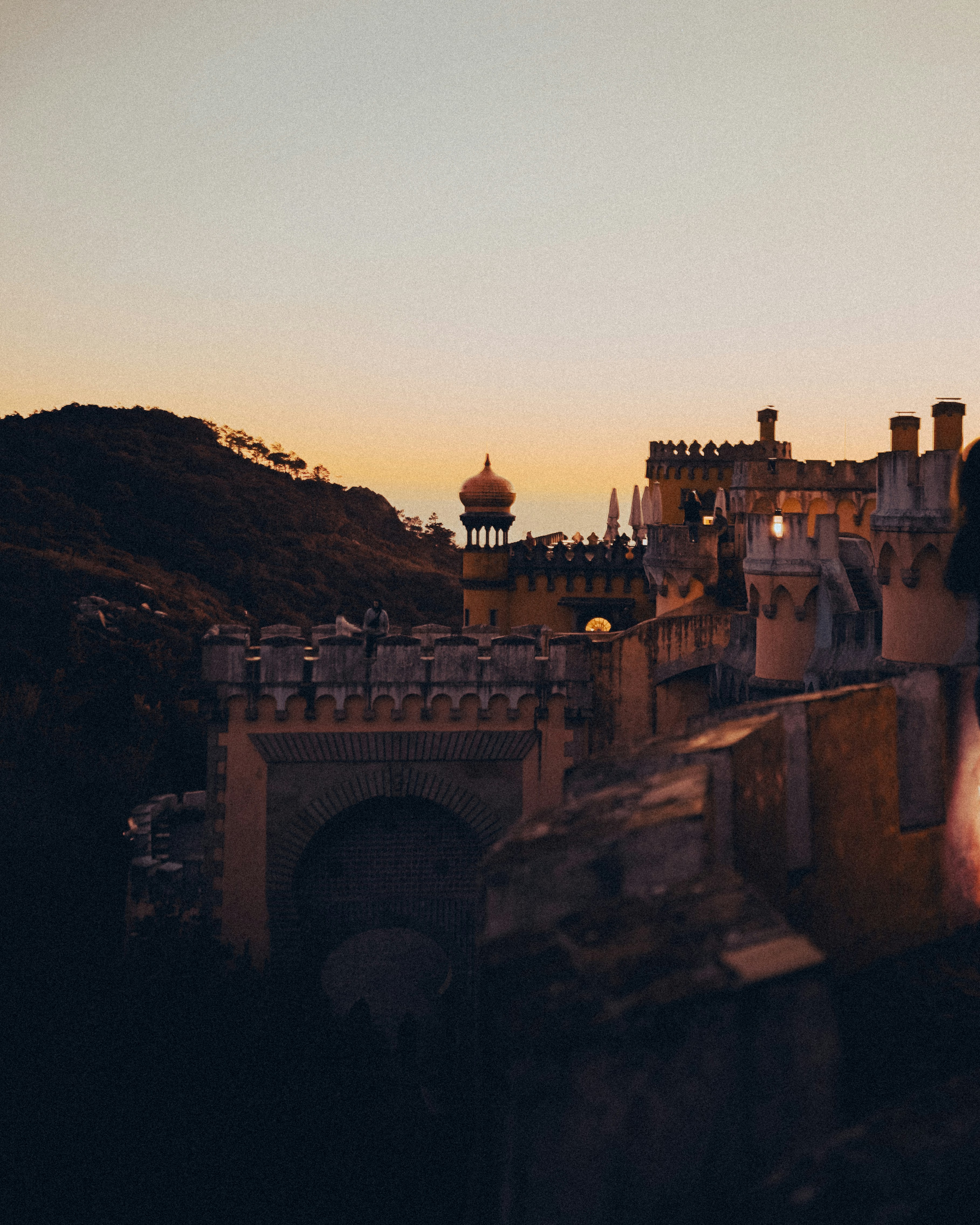 a person standing on top of a building next to a bridge