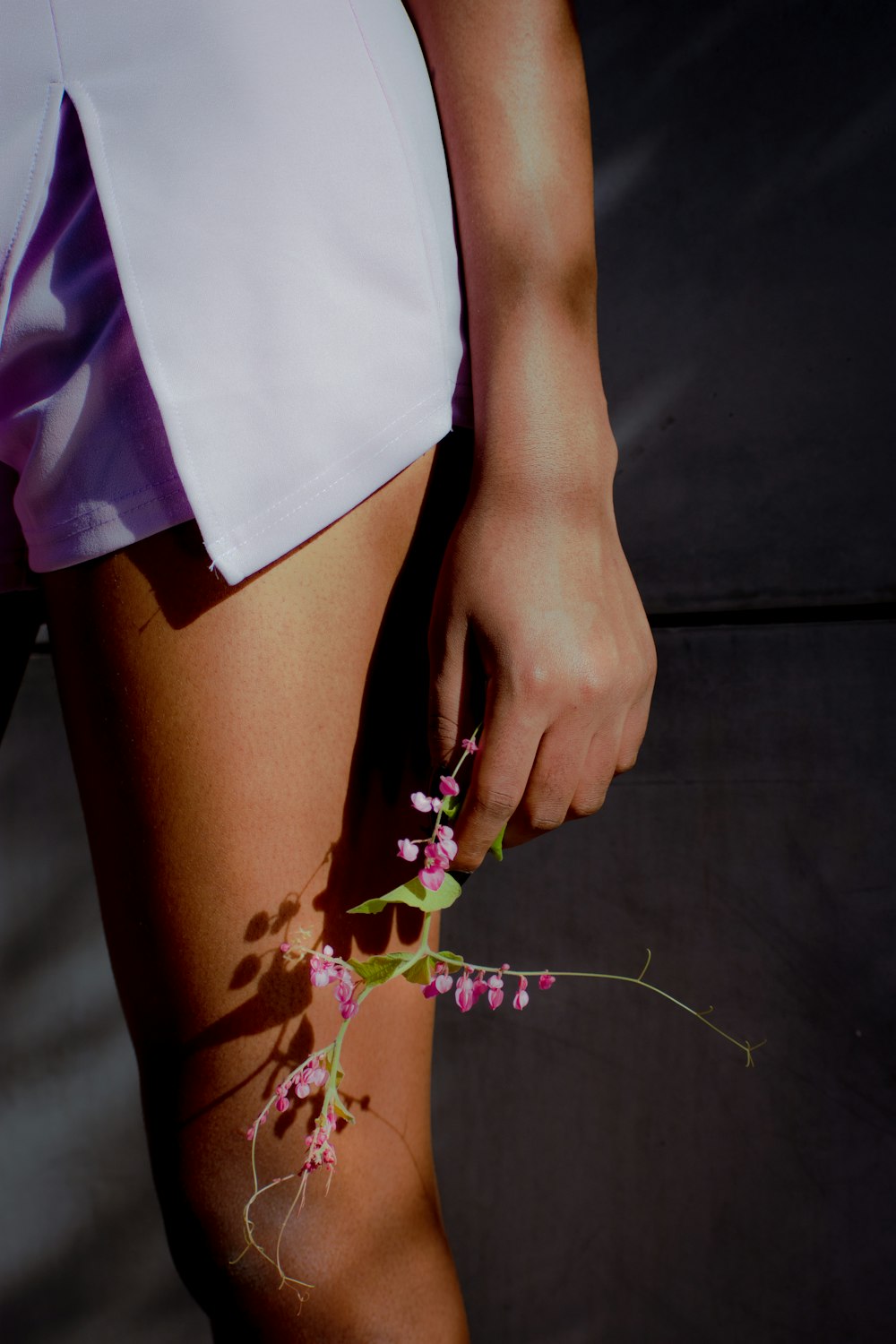 a close up of a person holding a flower